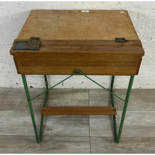 22 - A mid 20th century beech and plywood child's school desk on green painted tubular metal stand - appr... 