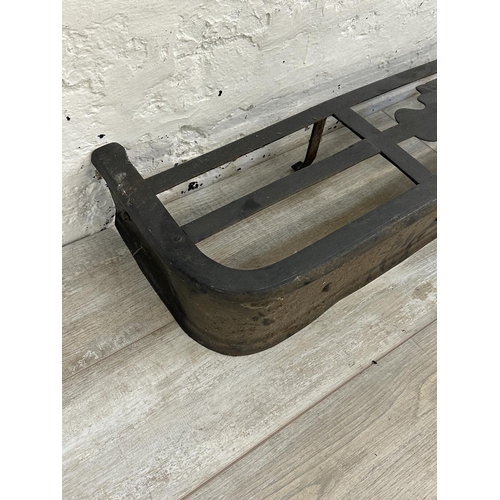 23 - A Victorian style black painted cast metal fire fender - approx. 16cm high x 120cm wide x 30cm deep