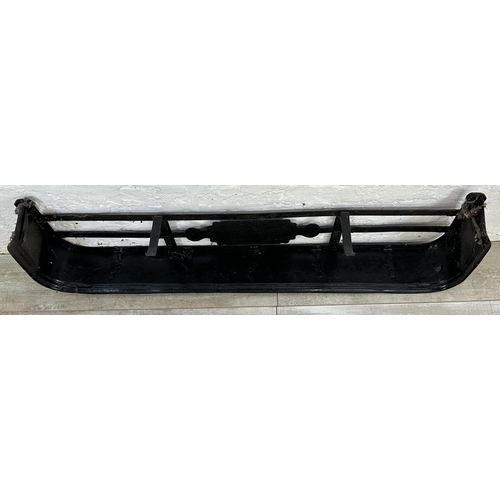 23 - A Victorian style black painted cast metal fire fender - approx. 16cm high x 120cm wide x 30cm deep