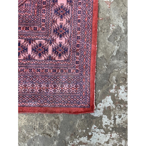 24A - A mid 20th century Bokhara rug - approx. 190cm x 130cm