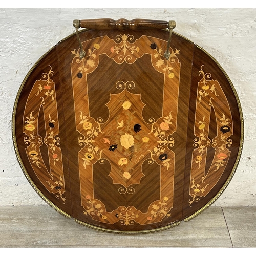 31 - An Italian Sorrento marquetry inlaid walnut two tier drinks trolley