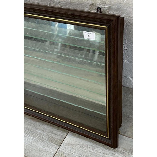 33 - An oak effect wall hanging model display cabinet with four glass shelves - approx. 43cm high x 61cm ... 