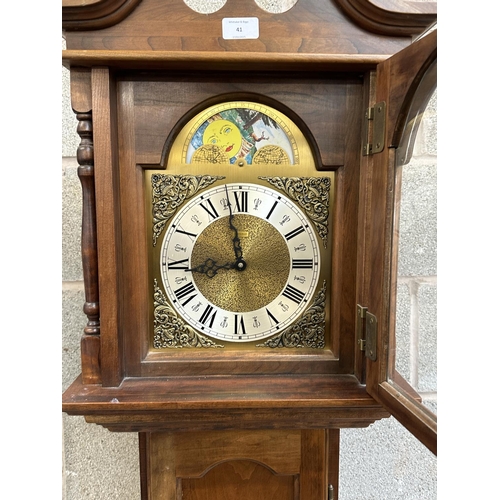 41 - A German Emperor walnut cased grandfather clock with pendulum and weights - approx. 188cm high