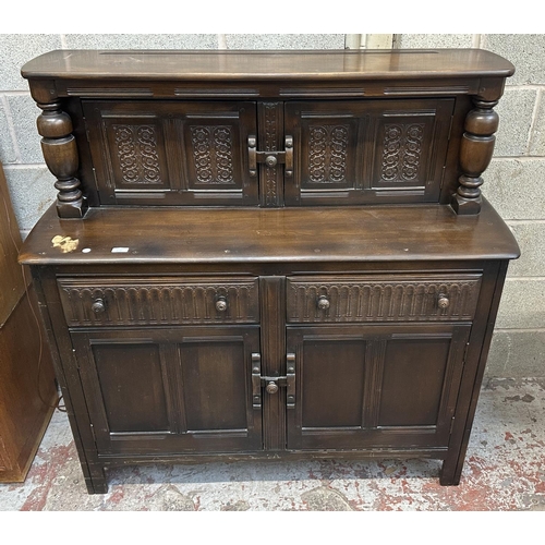 41A - An Ercol Old Colonial elm and beech court cupboard - approx. 131cm high x 130cm wide x 49cm deep