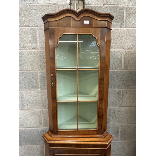 42 - A Georgian style yew wood free standing corner display cabinet