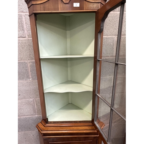 42 - A Georgian style yew wood free standing corner display cabinet