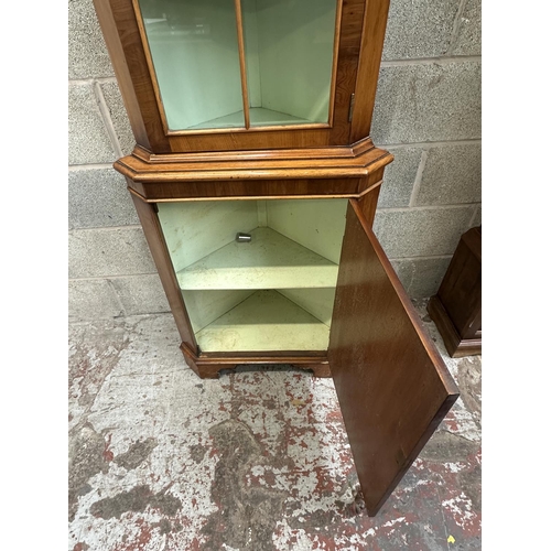 42 - A Georgian style yew wood free standing corner display cabinet