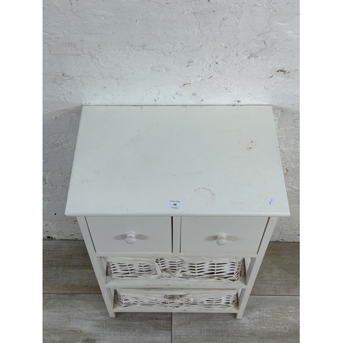 48 - A modern white painted cabinet with two wicker baskets - approx. 68cm high x 45cm wide x 30cm deep