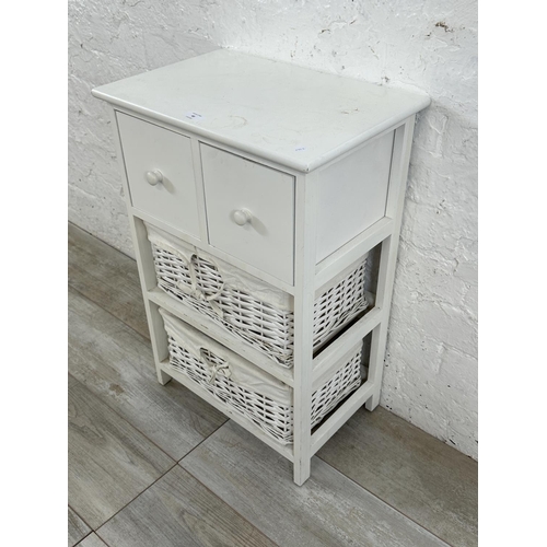 48 - A modern white painted cabinet with two wicker baskets - approx. 68cm high x 45cm wide x 30cm deep