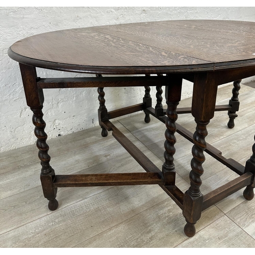 48A - An oak drop leaf gate leg barley twist dining table - approx. 71cm high x 105cm wide x 135cm long