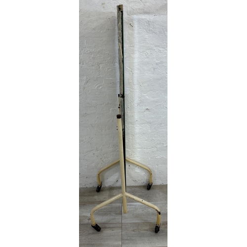 49 - A mid 20th century white painted tubular metal bevelled cheval mirror on castors - approx. 140cm hig... 