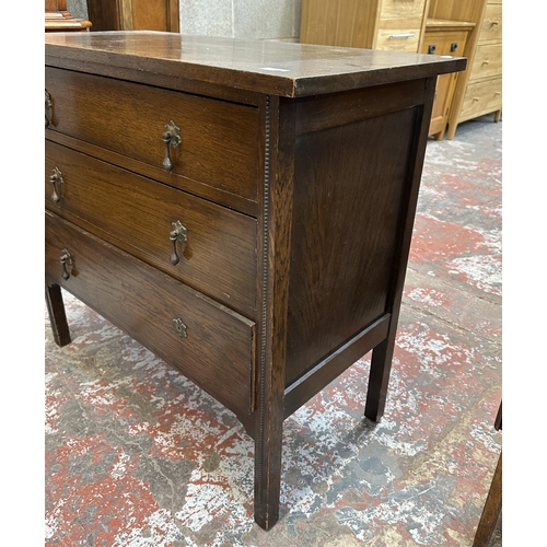 50 - An early 20th century oak chest of drawers - approx. 82cm high x 91cm wide x 45cm deep