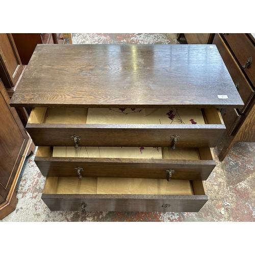 50 - An early 20th century oak chest of drawers - approx. 82cm high x 91cm wide x 45cm deep