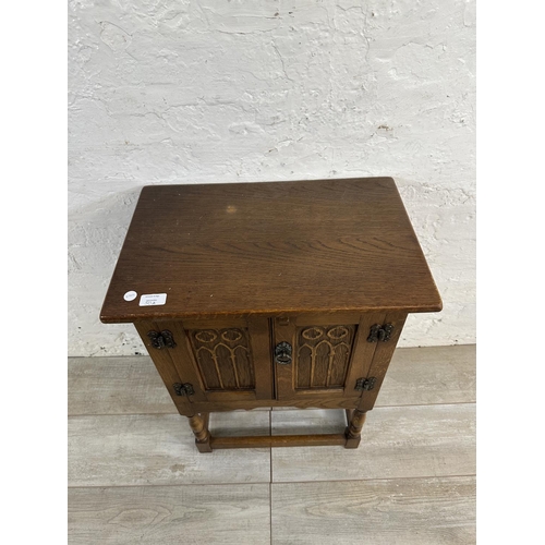 50A - A 17th century style carved oak side cabinet - approx. 68cm high x 50cm wide x 33cm deep