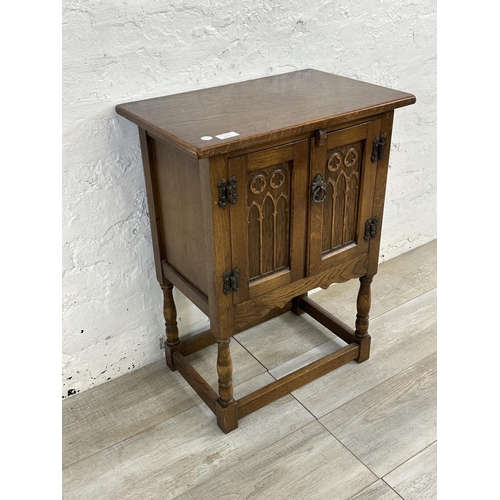 50A - A 17th century style carved oak side cabinet - approx. 68cm high x 50cm wide x 33cm deep