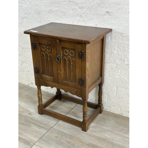 50A - A 17th century style carved oak side cabinet - approx. 68cm high x 50cm wide x 33cm deep