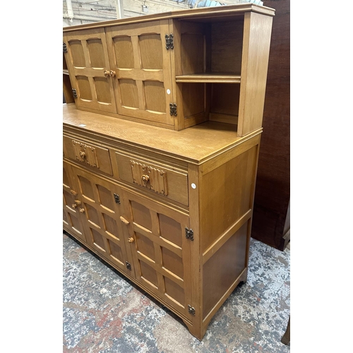 55 - A carved oak court cupboard - approx. 135cm high x 138cm wide x 46cm deep