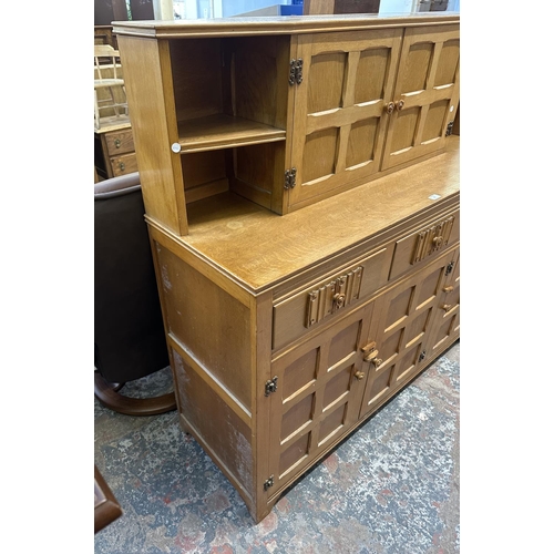 55 - A carved oak court cupboard - approx. 135cm high x 138cm wide x 46cm deep