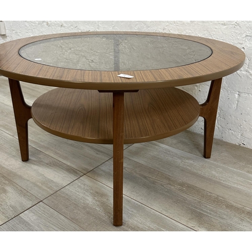 6 - A mid 20th century laminated teak and smoked glass circular two tier coffee table - approx. 46cm hig... 