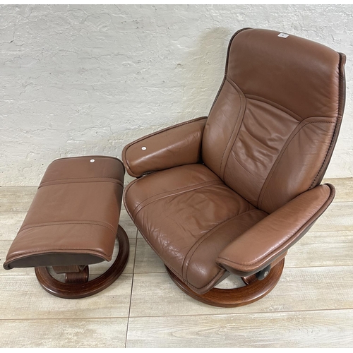 66 - An Ekornes Stressless brown leather and bentwood swivel reclining armchair and footstool