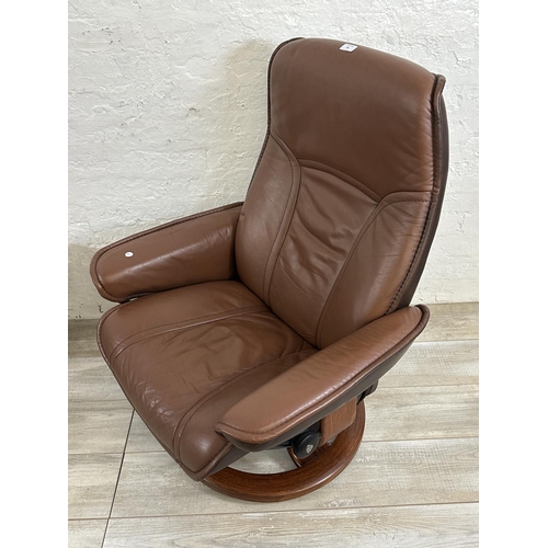 66 - An Ekornes Stressless brown leather and bentwood swivel reclining armchair and footstool