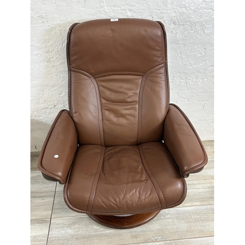 66 - An Ekornes Stressless brown leather and bentwood swivel reclining armchair and footstool