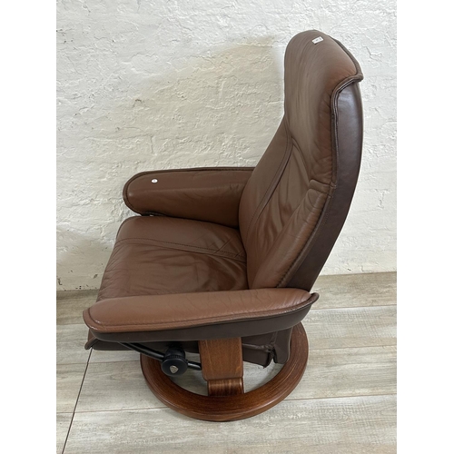 66 - An Ekornes Stressless brown leather and bentwood swivel reclining armchair and footstool