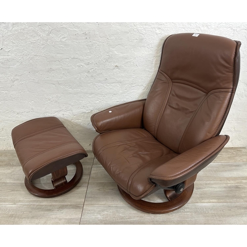 67 - An Ekornes Stressless brown leather and bentwood swivel reclining armchair and footstool