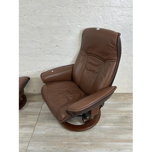 67 - An Ekornes Stressless brown leather and bentwood swivel reclining armchair and footstool