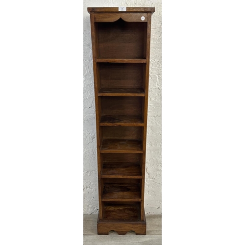 69 - An Indian sheesham wood seven tier bookcase - approx. 147cm high x 34cm wide x 19cm deep