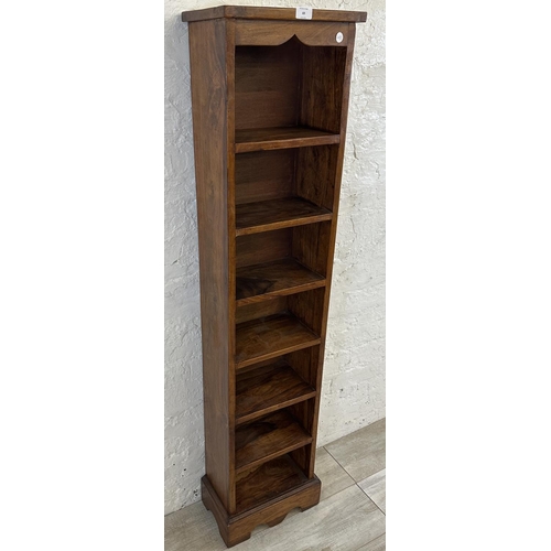 69 - An Indian sheesham wood seven tier bookcase - approx. 147cm high x 34cm wide x 19cm deep