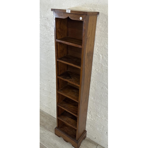 69 - An Indian sheesham wood seven tier bookcase - approx. 147cm high x 34cm wide x 19cm deep