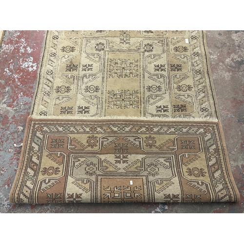 7 - A mid/late 20th century machine woven tasselled rug - approx. 200cm x 120cm