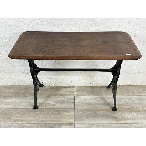 87 - A Victorian cast iron and mahogany outdoor pub table - approx. 75cm high x 51cm wide x 108cm long