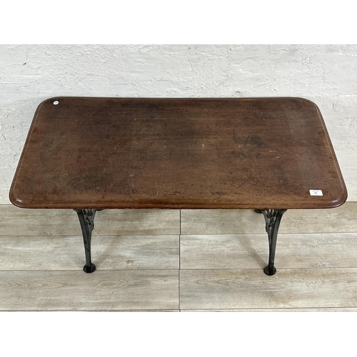 87 - A Victorian cast iron and mahogany outdoor pub table - approx. 75cm high x 51cm wide x 108cm long