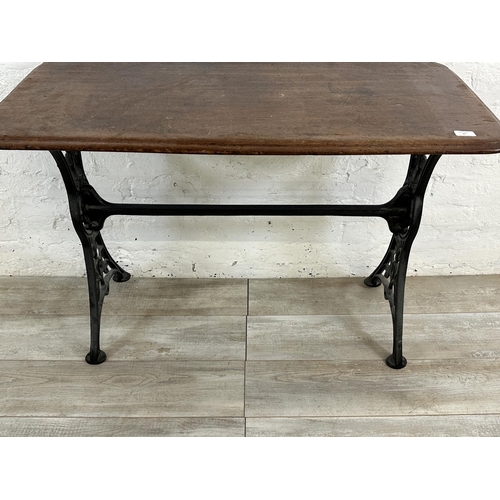 87 - A Victorian cast iron and mahogany outdoor pub table - approx. 75cm high x 51cm wide x 108cm long