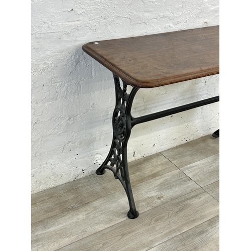 87 - A Victorian cast iron and mahogany outdoor pub table - approx. 75cm high x 51cm wide x 108cm long