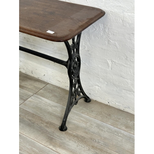 87 - A Victorian cast iron and mahogany outdoor pub table - approx. 75cm high x 51cm wide x 108cm long