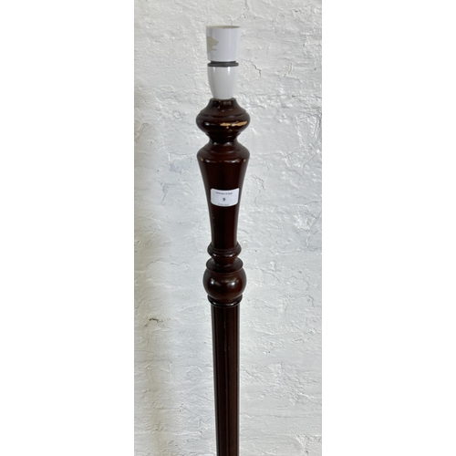 9 - A mid/late 20th century stained beech standard lamp on circular base - approx. 131cm high