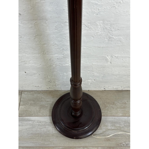 9 - A mid/late 20th century stained beech standard lamp on circular base - approx. 131cm high