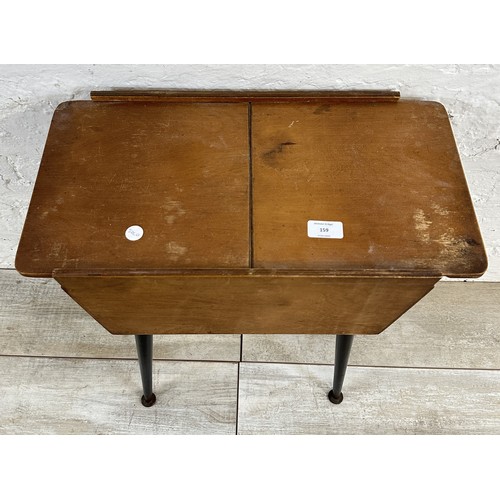 159 - A mid 20th century beech and plywood sewing box on atomic supports - approx. 57cm high x 50cm wide x... 