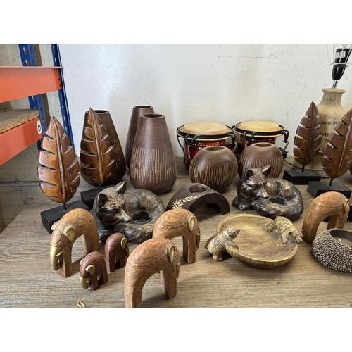 423 - A collection of items to include wooden squirrel bowl, bongos, stoneware lamp etc.