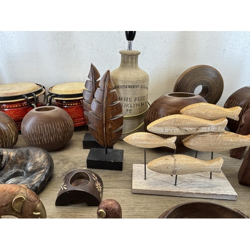 423 - A collection of items to include wooden squirrel bowl, bongos, stoneware lamp etc.