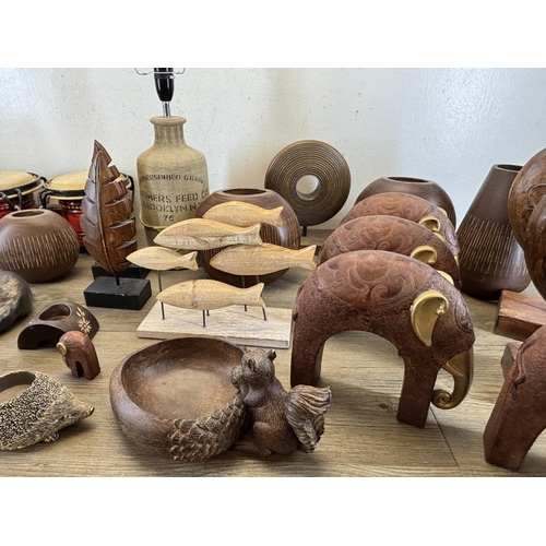 423 - A collection of items to include wooden squirrel bowl, bongos, stoneware lamp etc.