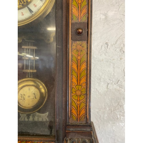 2A - A late 19th century walnut cased chiming wall clock with hand painted floral decoration, enamel face... 