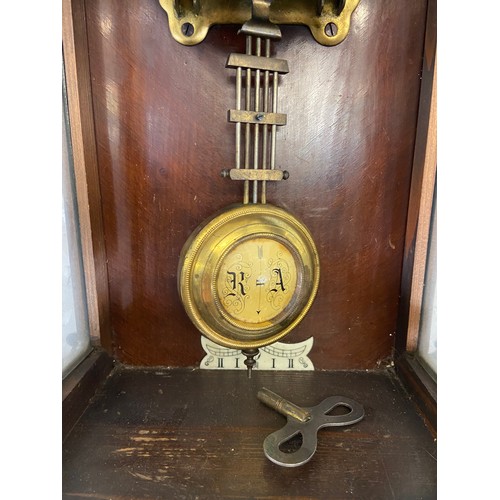 2A - A late 19th century walnut cased chiming wall clock with hand painted floral decoration, enamel face... 