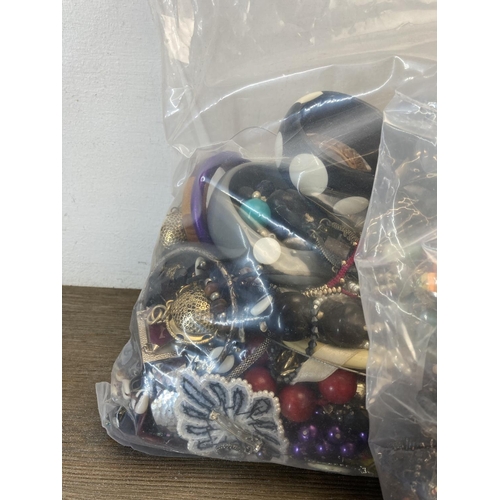 381 - Three bags containing costume jewellery