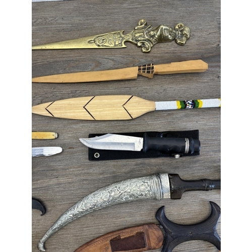 432 - A collection of items to include replica flintlock pistol, various pocket knives, cut throat razors ... 