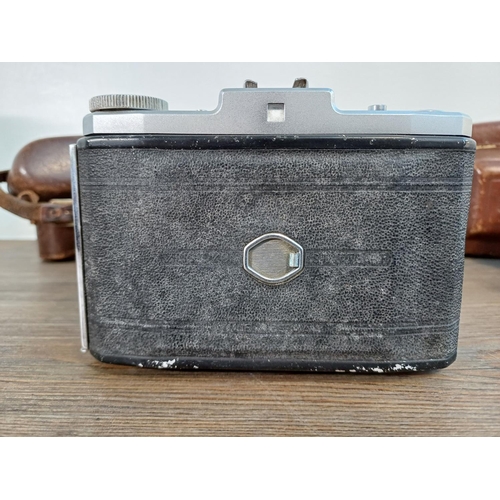 73 - Two cased 1950s Zeiss Ikon Nettar II self-erecting folding cameras for 6x6 images on 120 film with i... 