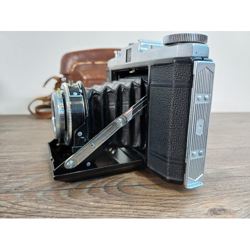 73 - Two cased 1950s Zeiss Ikon Nettar II self-erecting folding cameras for 6x6 images on 120 film with i... 